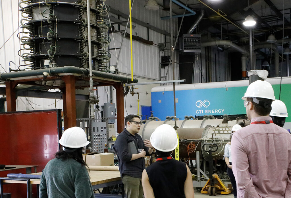 GTI Energy employee giving a tour of one of our many labs