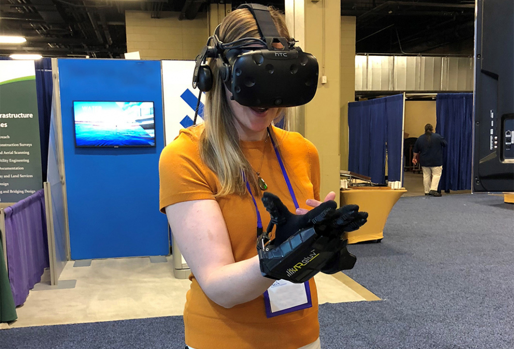 woman wearing Virtual Reality goggles and hand glove controller