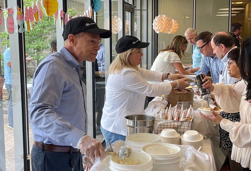 GTI Energy staff at the ice cream table being served custom sundaes at our annual Ice Cream Social