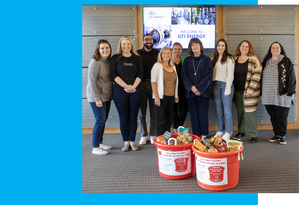 GTI Energy employees standing behind our food drive bins full of donated food