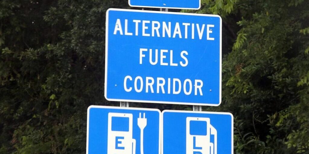 Roads sign that says Begin Alternative Fuels Corridor with EV fueling and LPG fueling icons