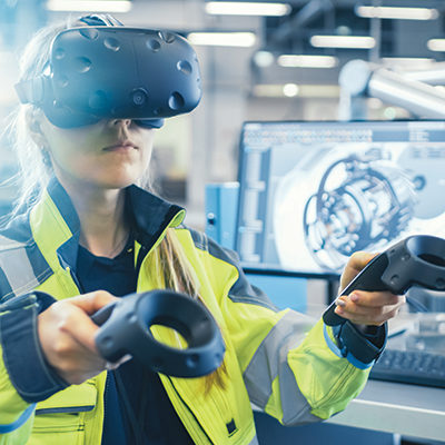 woman wearing VR goggles using hand controllers