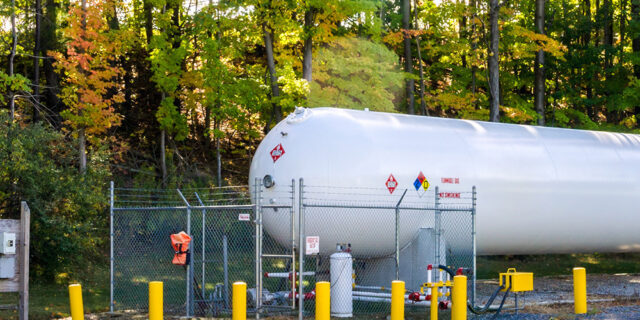 Single Cool LPG tank in front of trees